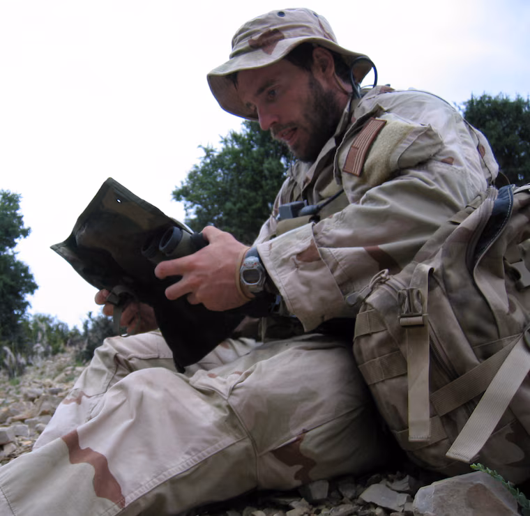 Murphy reading a book during a break on deployment